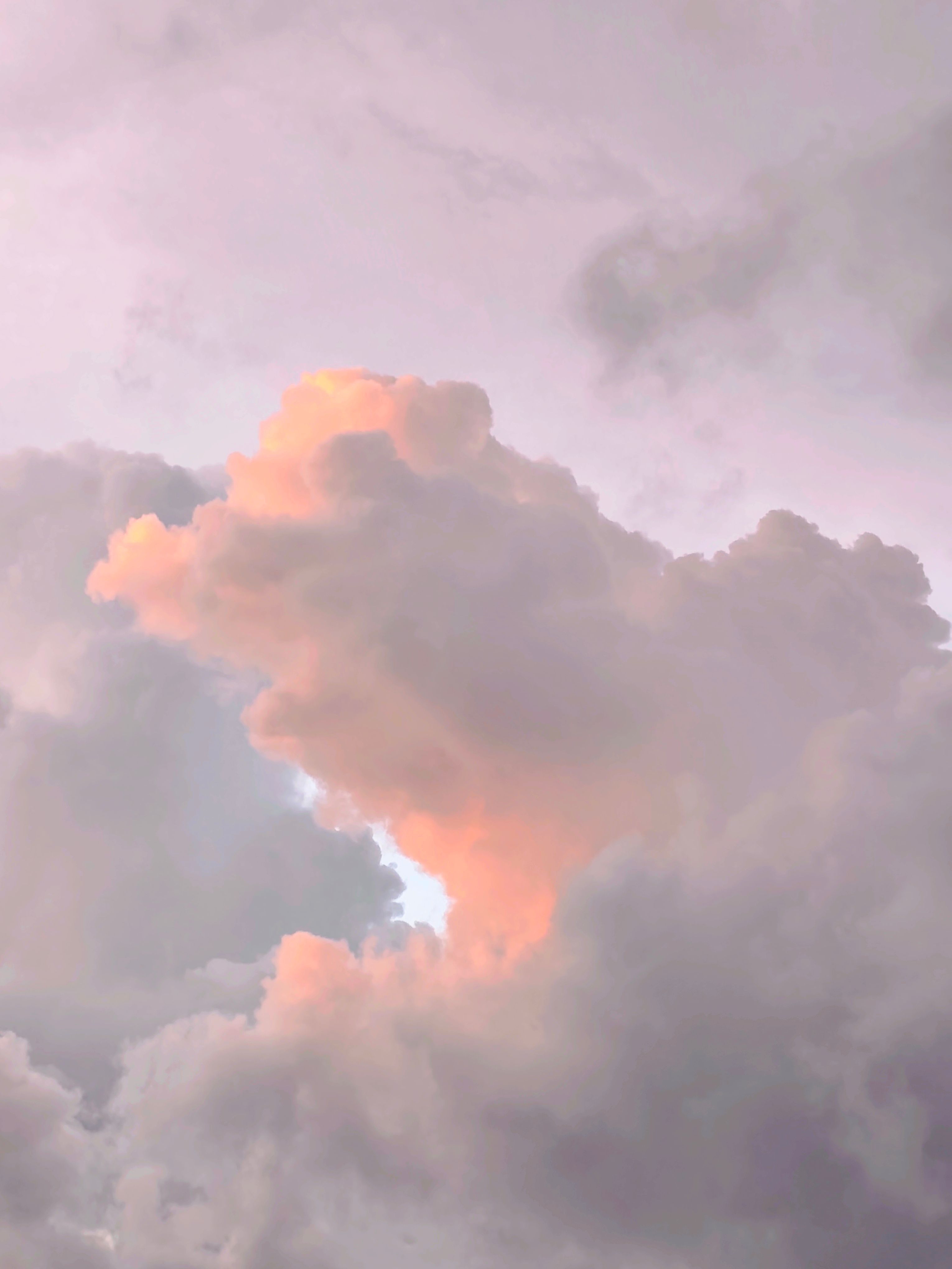 Beautiful fluffy clouds with warm sunset glow in Philippine sky.