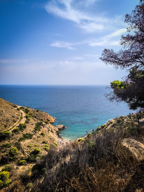 Free Breathtaking view of a rocky cliff and blue Mediterranean Sea under a clear sky. Stock Photo