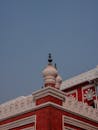 Ornate Red Brick Building Under Clear Blue Sky