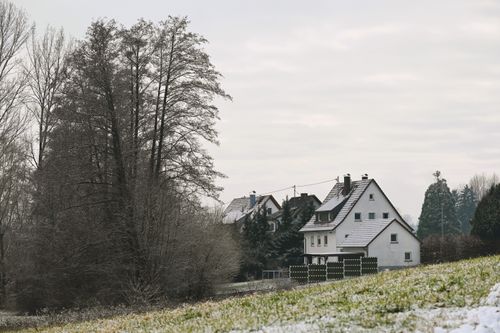 Free Snowy village landscape in Baden-Württemberg, highlighting winter trees and German architecture. Stock Photo
