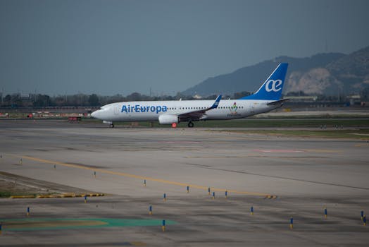 Air Europa Boeing 737 on a runway preparing for departure against a mountainous backdrop.