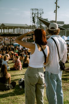 Young couple at a summer music festival enjoying the outdoor concert scenery.