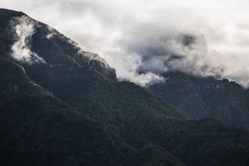 Free Dramatic misty mountains with lush greenery in Madeira, Portugal. Captivating natural landscape. Stock Photo