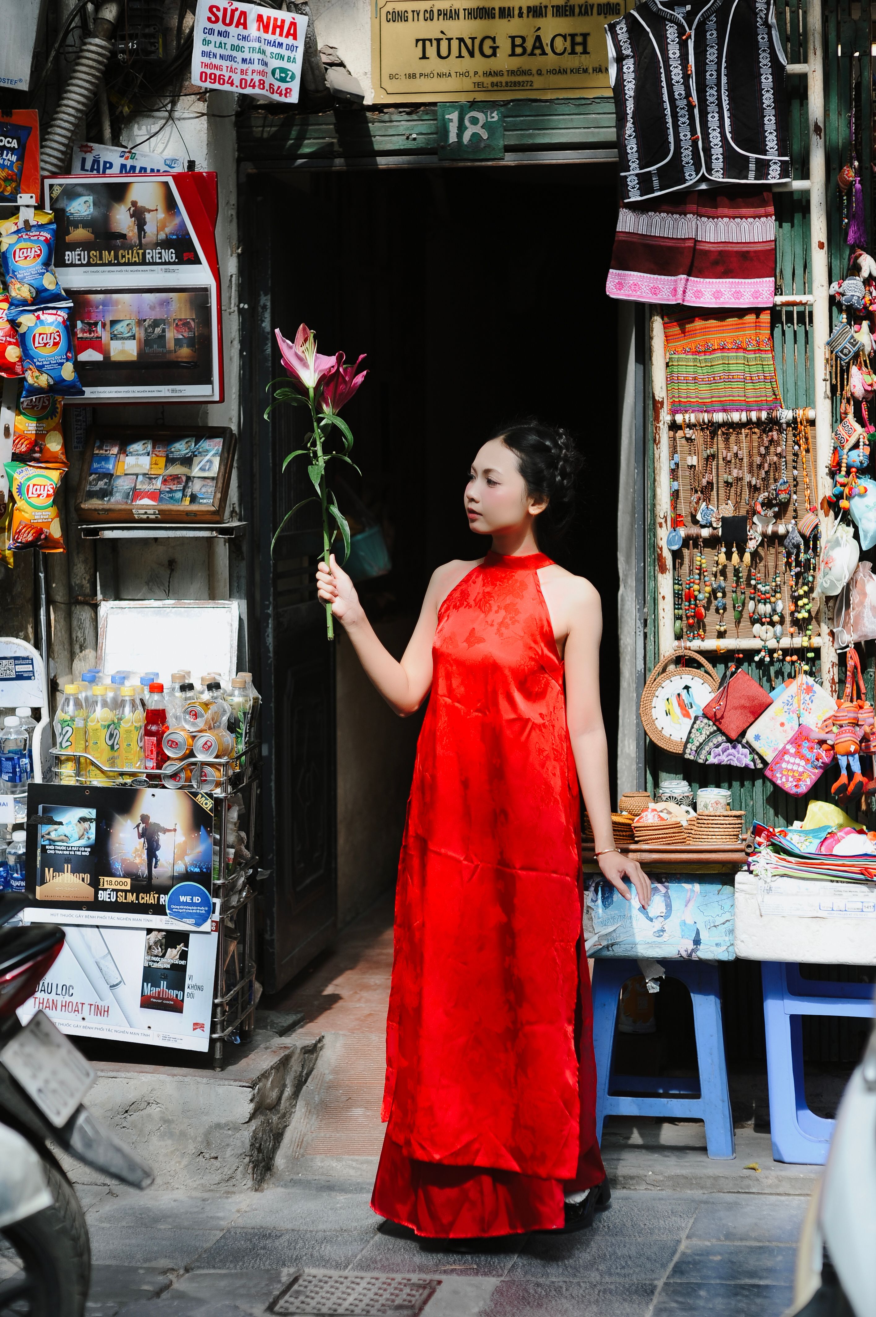 Elegant Woman in Red Dress Holding a Lily · Free Stock Photo