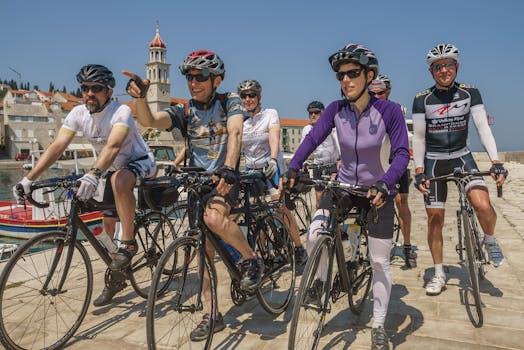 Cyclists gather for a ride along the scenic Adriatic coast in a sunny European town.