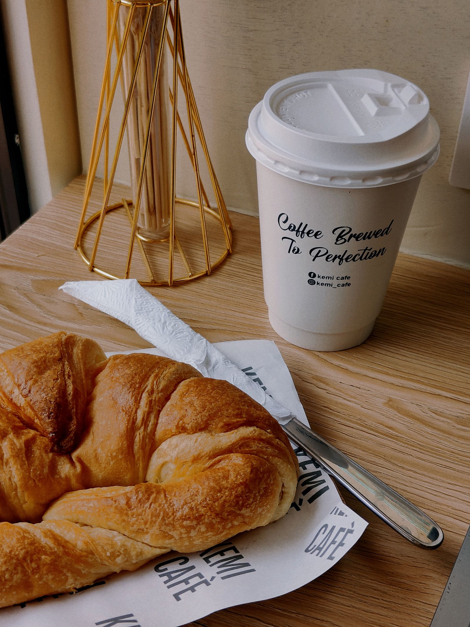 Coffee and croissant on a cafe table