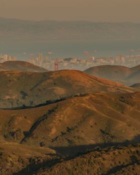 Scenic view of the Golden Gate Bridge and San Francisco from the Marin Hills at sunset.