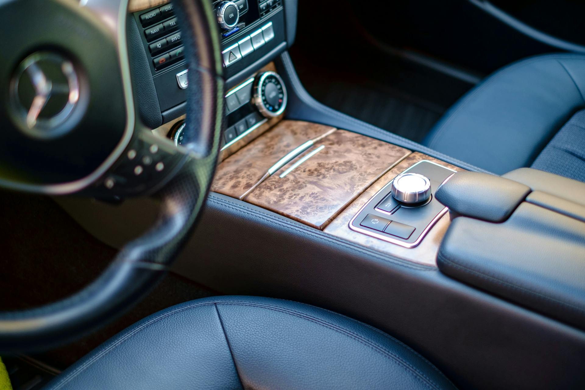 High-end car interior featuring leather seats and wood accents. Sleek and modern design.