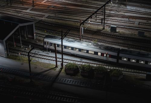Free Aerial night view of a train on tracks in Copenhagen, Denmark. Stock Photo