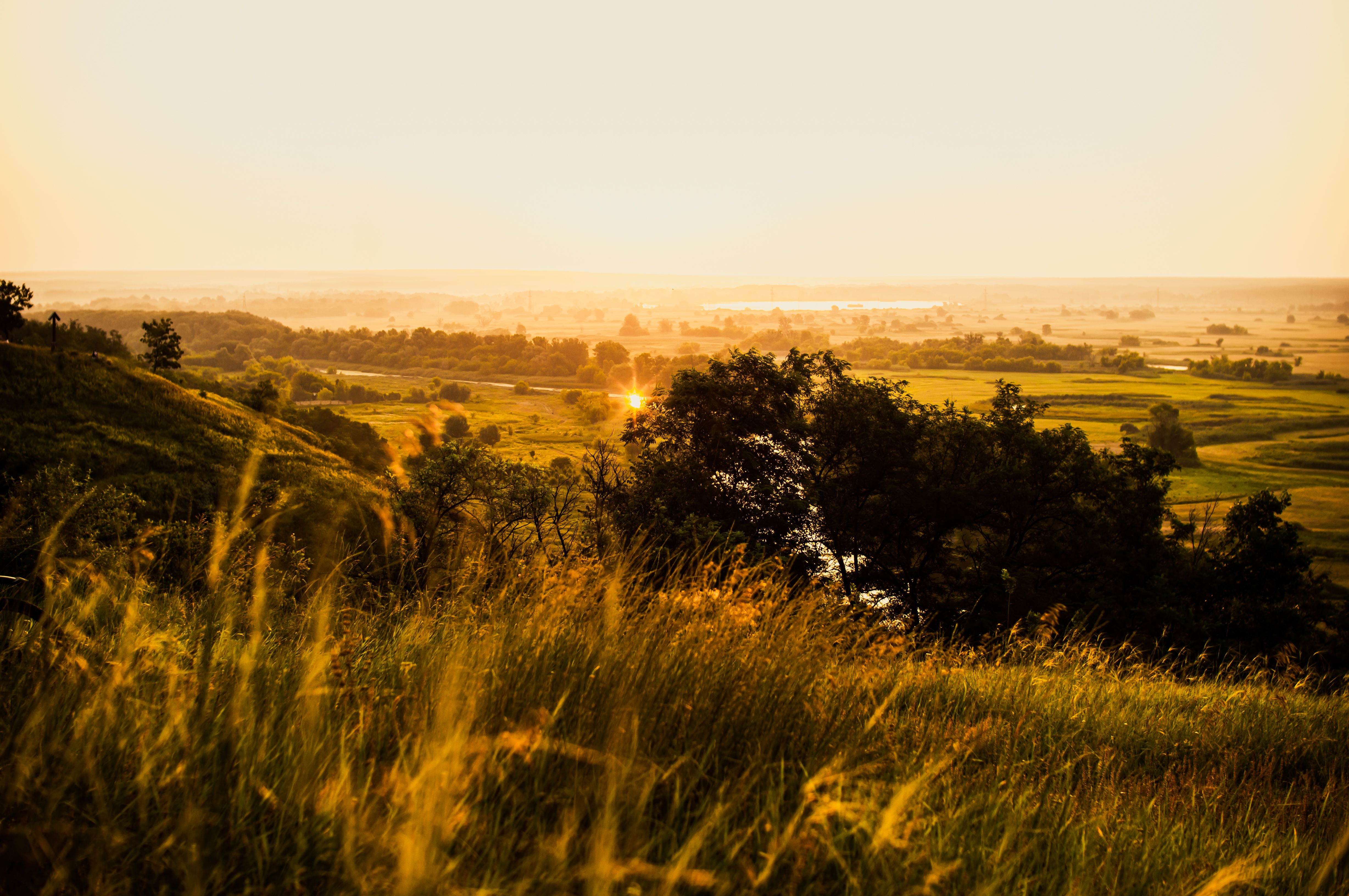 Golden Sunset Over Rolling Hills Landscape · Free Stock Photo