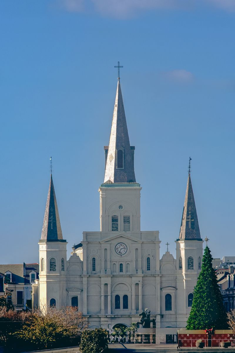 The iconic white St. Louis Cathedral with three spires in New Orleans