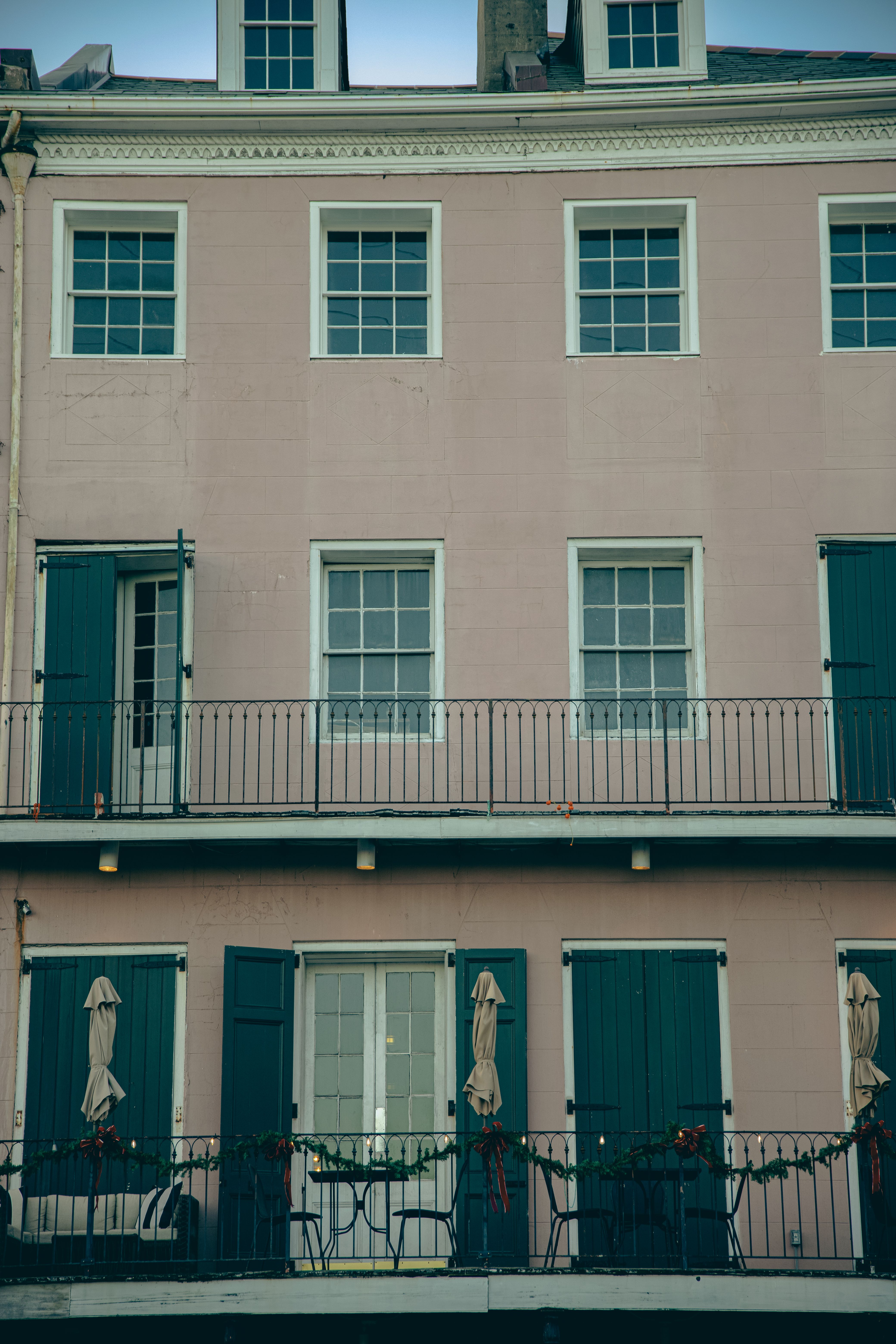 Historic New Orleans French Quarter building with blue shutters and balconies