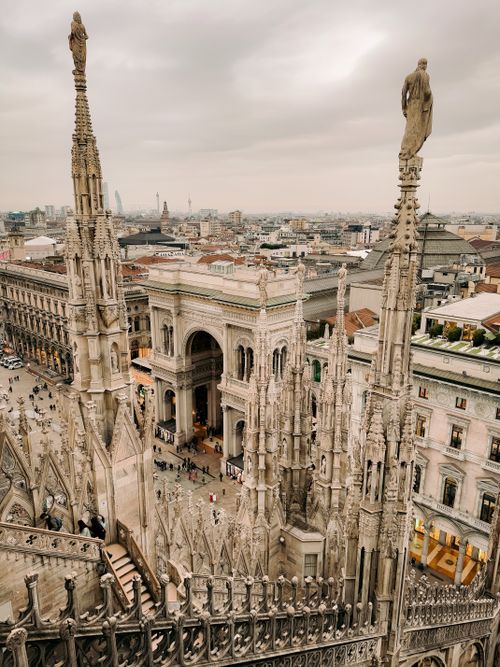 Free Stunning aerial view of Milan, showcasing the ornate Gothic spires and bustling city life. Stock Photo