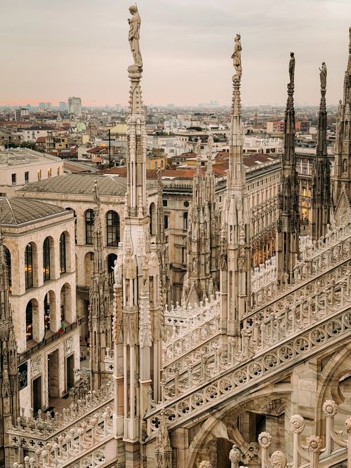 Free A stunning view of Milan Cathedral's intricate Gothic spires against the cityscape during twilight. Stock Photo