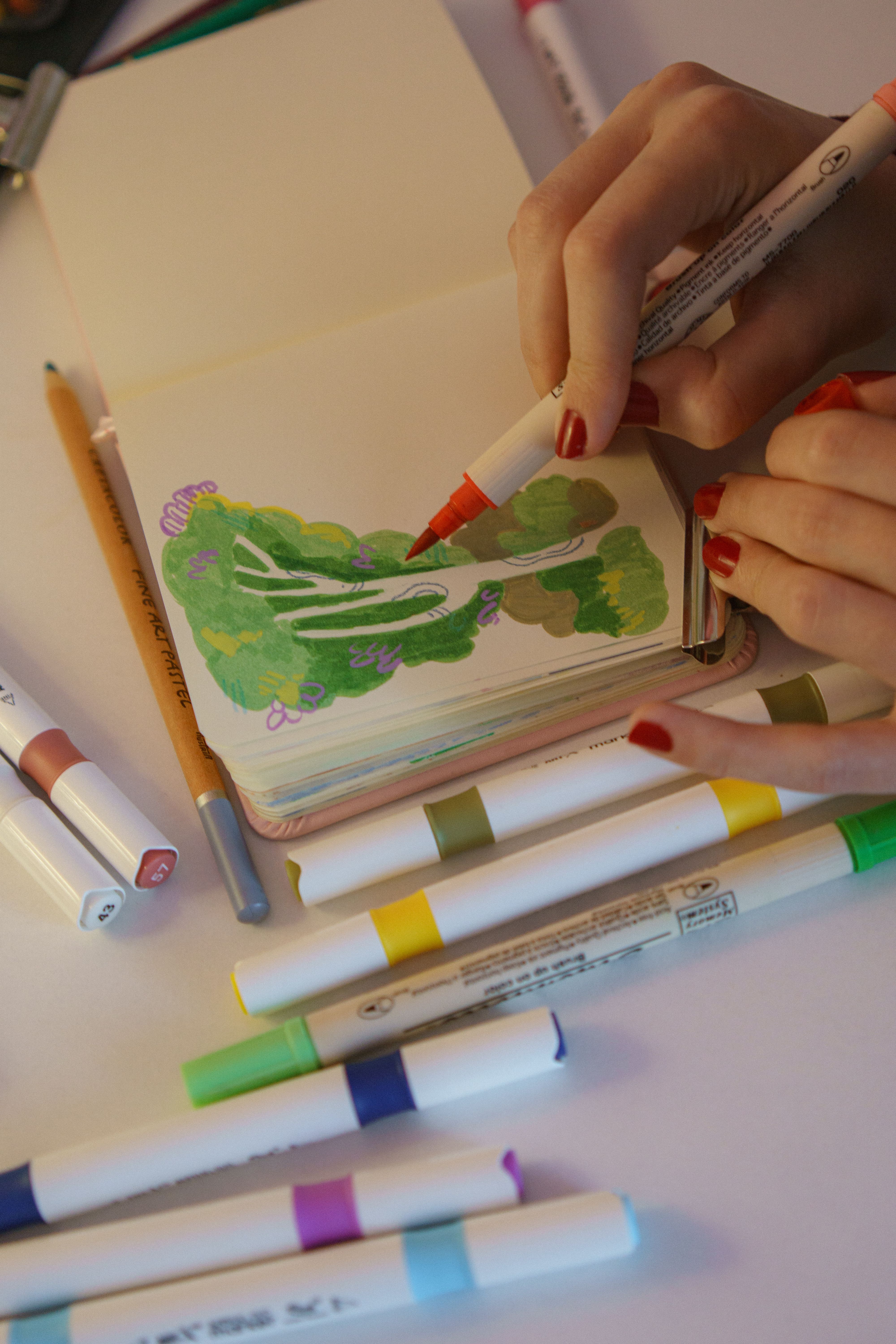 Creative Drawing with Markers in Sketchbook · Free Stock Photo