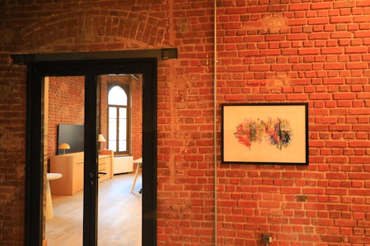 Warm indoor space with brick walls, art, and soft lighting in İstanbul setting.