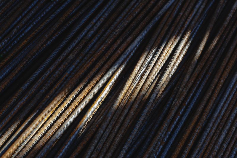 Artistic close-up of steel rebars with dramatic lighting