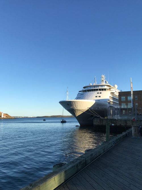 Free Large cruise ship docked at city port under clear blue sky, urban exploration. Stock Photo