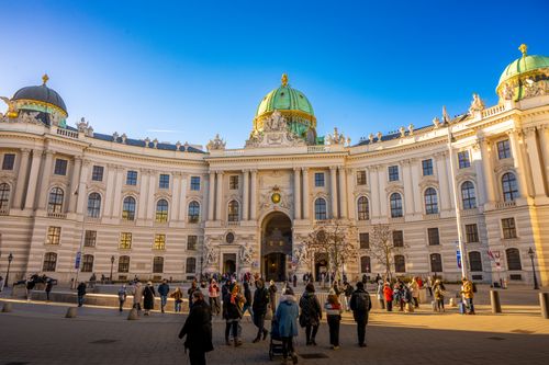 Free A vibrant scene outside Hofburg Palace in Vienna with a crowd enjoying the sunny day. Stock Photo