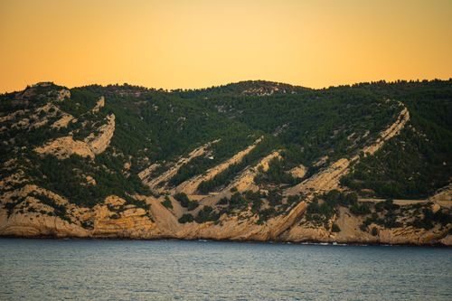 Free Breathtaking view of Calanque cliffs near Marseille at sunset with serene sea. Stock Photo