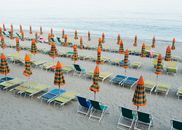 Parasols and Beach Chairs on Sand Near Sea