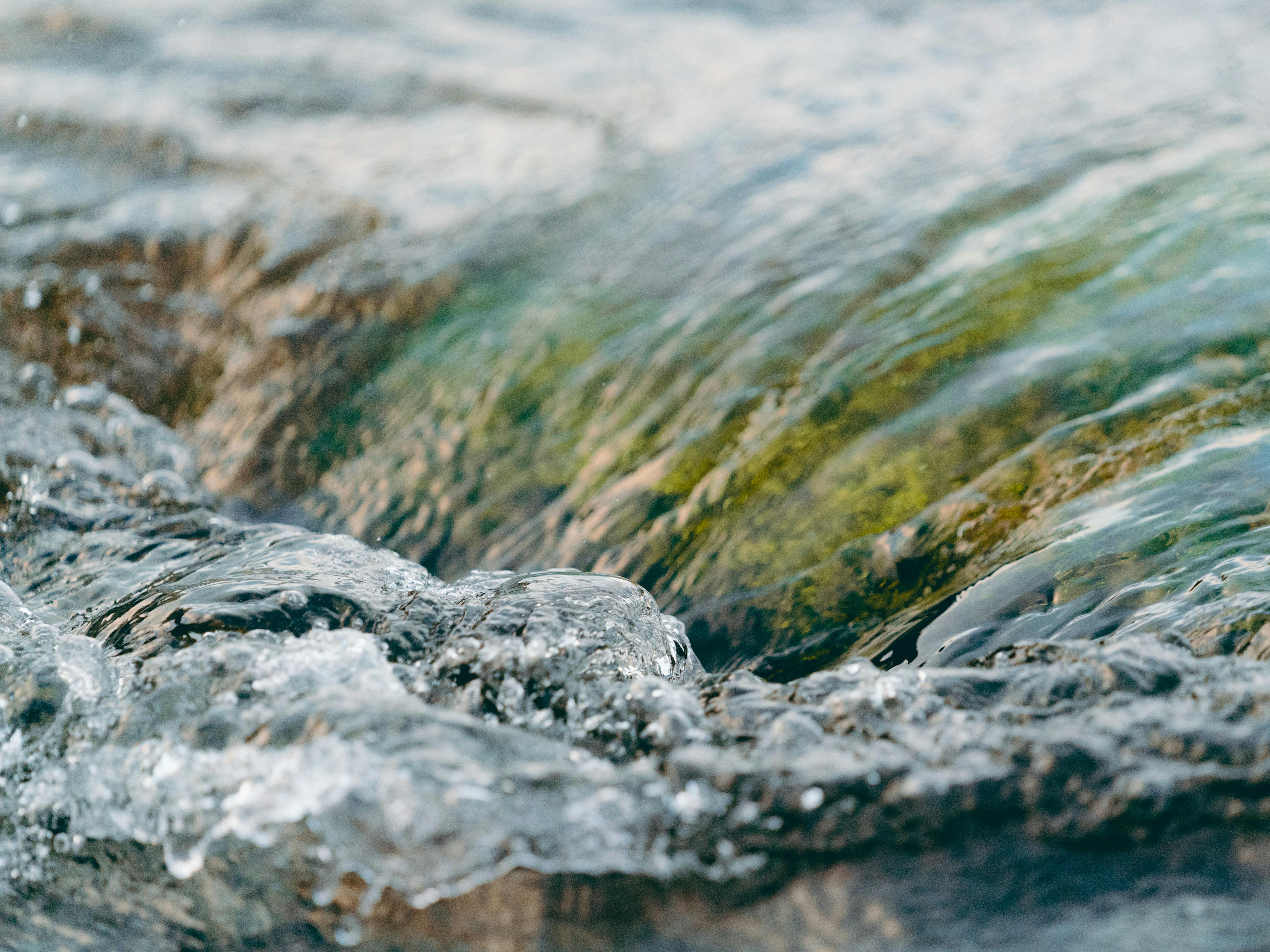 water flowing under stone