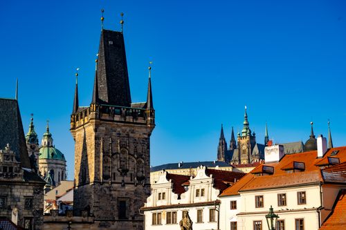 Free Capture of Prague's historic skyline featuring St. Vitus Cathedral and medieval towers under a clear blue sky. Stock Photo