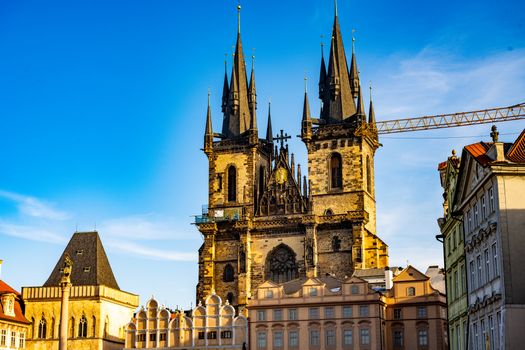 The stunning Gothic spires of Týn Church rise against a clear blue sky in Prague.