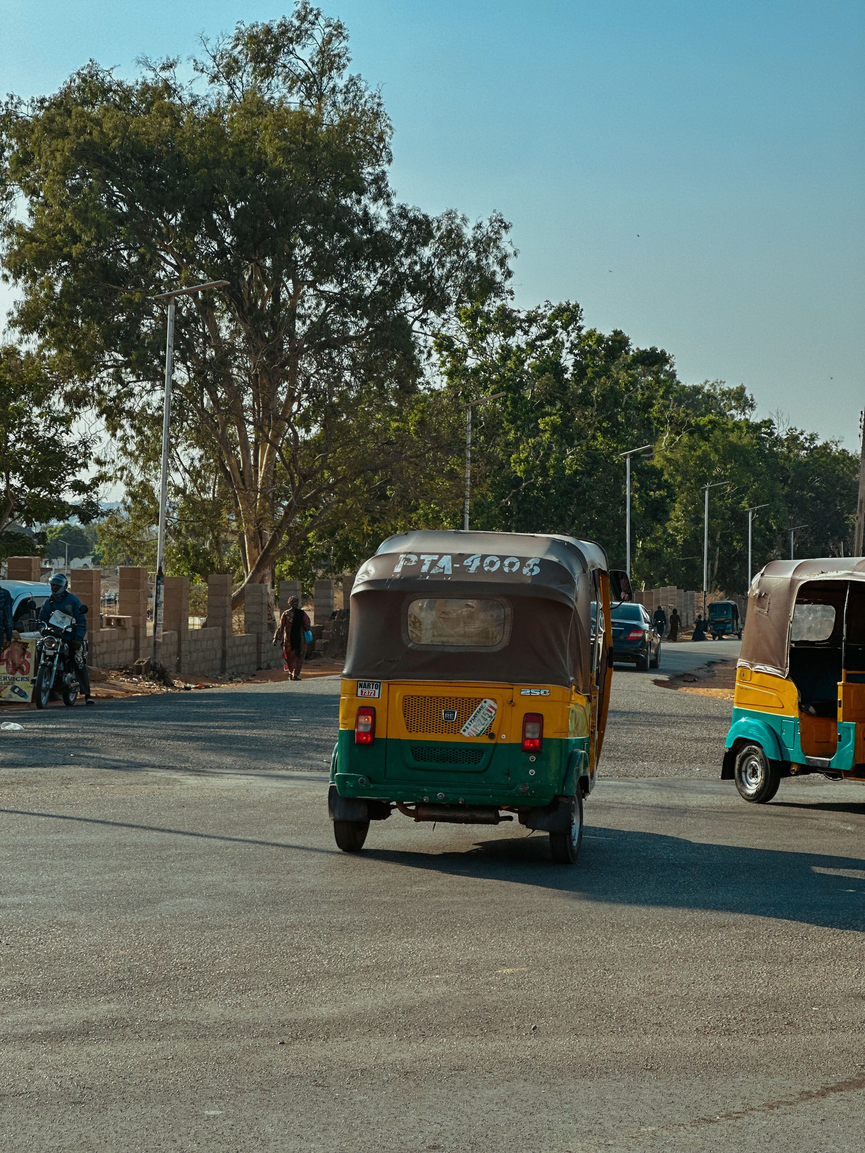 Colorful Auto Rickshaws on a Sunny Street · Free Stock Photo