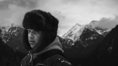 Traveller in a fur hat before snowbound peaks — photo by Ehaan Dewa on Pexels