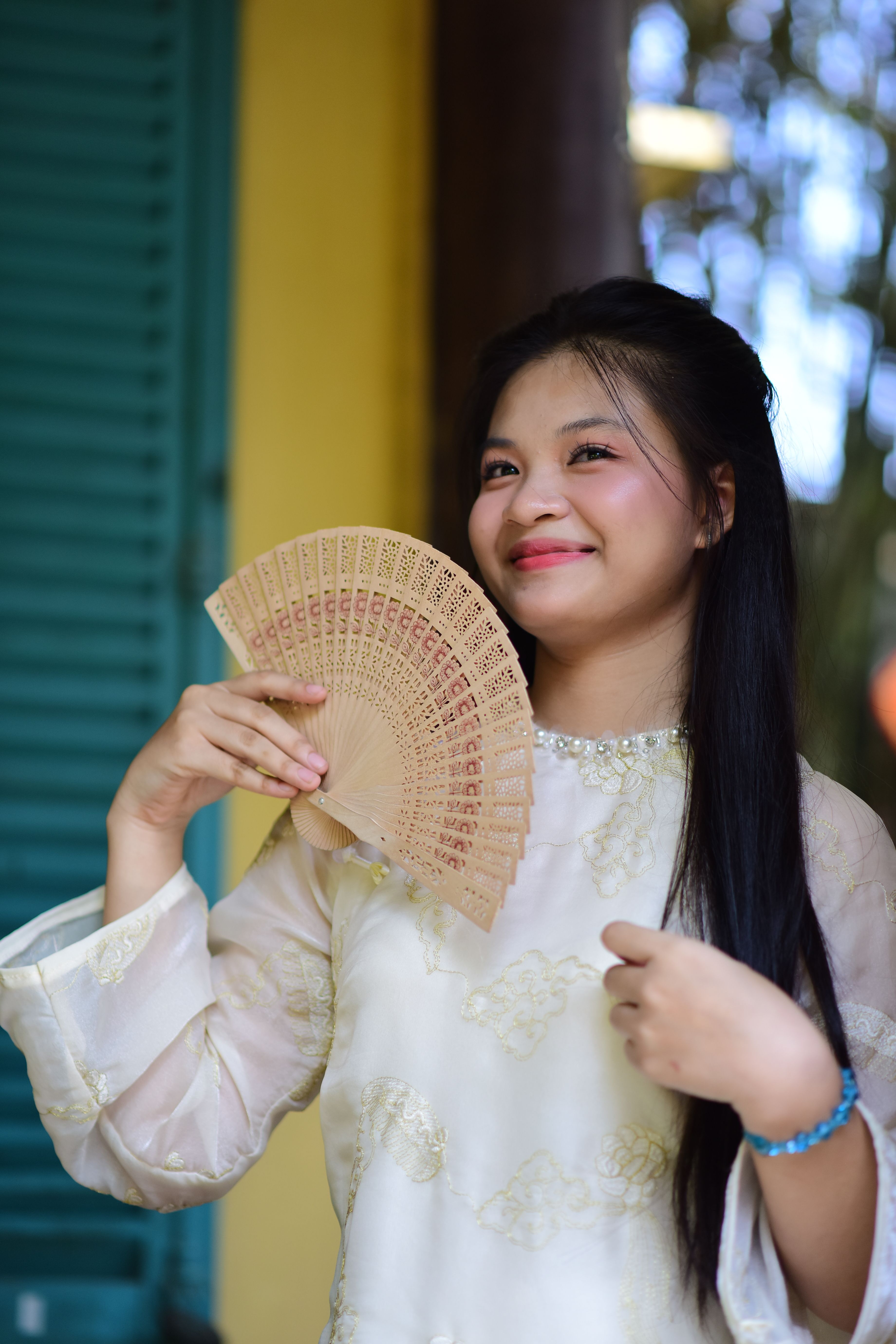 Woman Holding Hand Fan in Cultural Attire · Free Stock Photo