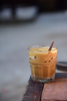 Refreshing glass of iced coffee on a wooden table, capturing the essence of a cool beverage experience.