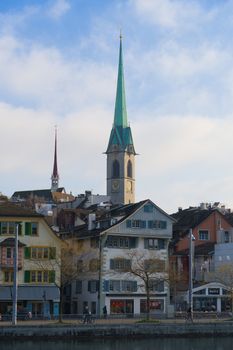 Charming view of Fraumünster Church spire against Zurich's vibrant skyline.
