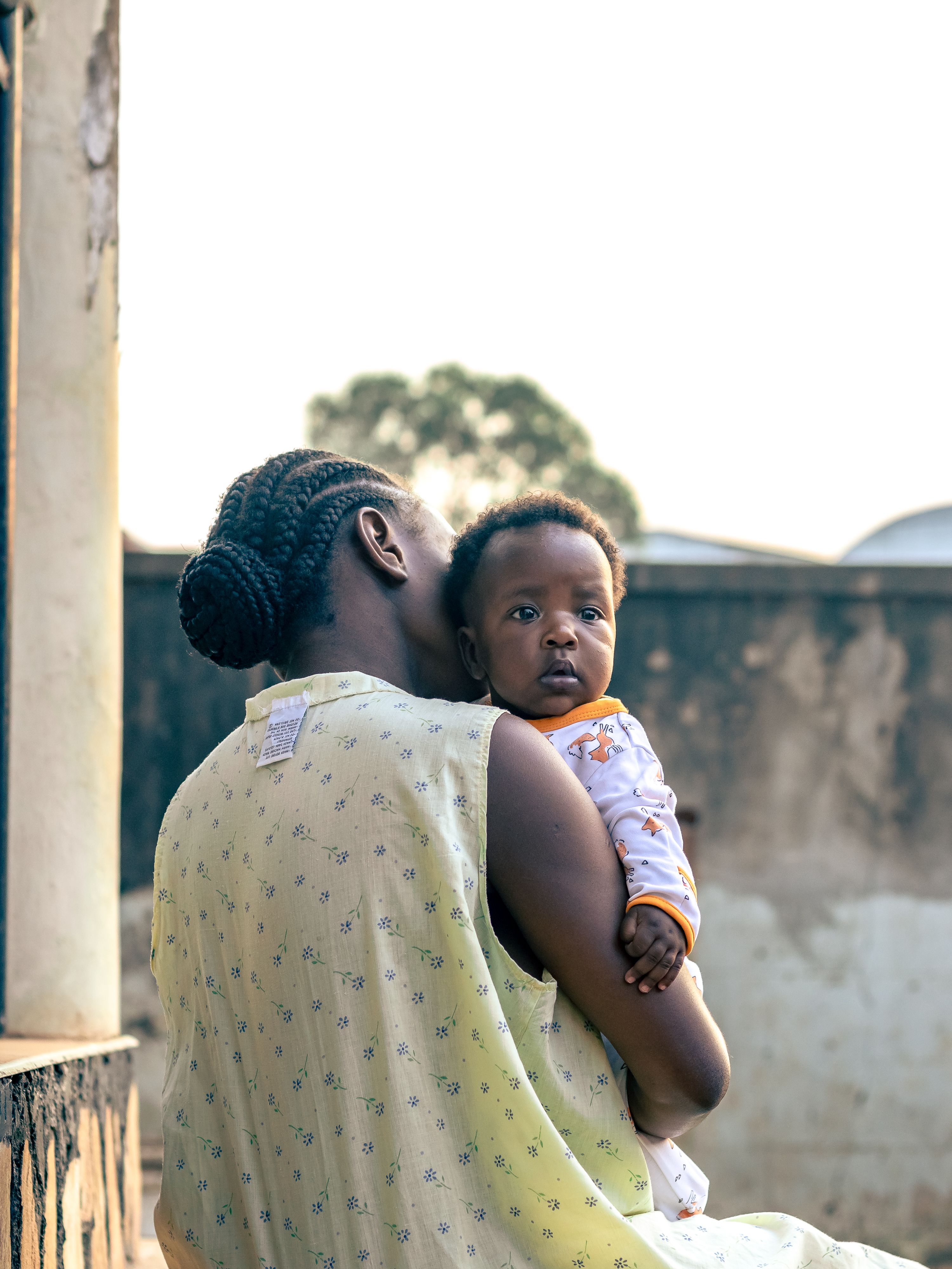 A mother holding her baby outdoors in daylight — with the right treatment, most mothers with perinatal mental health conditions recover fully
