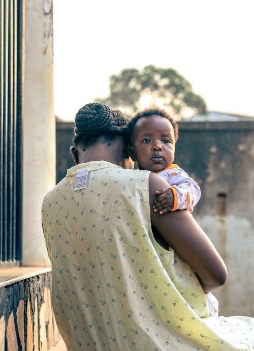 Free Heartwarming scene of a mother holding her baby outside, capturing a moment of tenderness. Stock Photo