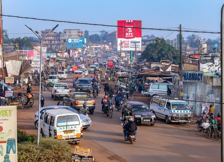 A vibrant and busy street in Kampala, Uganda, showcasing daily life and local transportation.