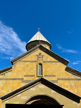 A historic church with a distinct architectural dome against a vibrant blue sky.