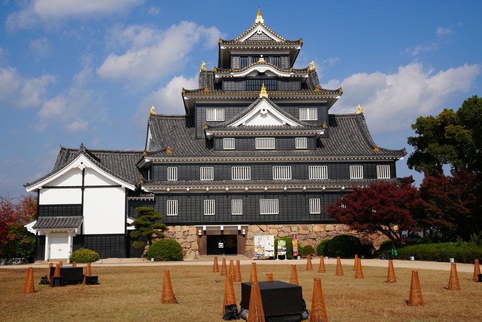 Stunning view of Okayama Castle during autumn. Clear skies enhance the beauty of its historic architecture.
