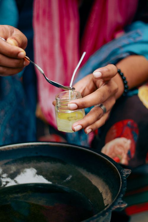 Free Hands crafting eco-friendly candles using organic ingredients in Dhaka, Bangladesh. Stock Photo