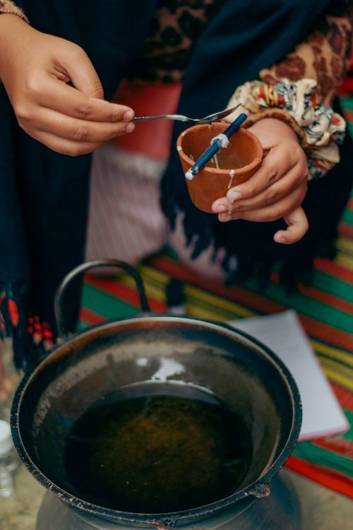 Free Hands demonstrating traditional eco-friendly candle making in Dhaka, Bangladesh. Stock Photo