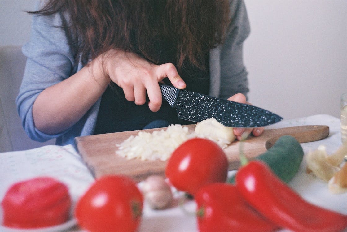 Woman dicing tomatoes
