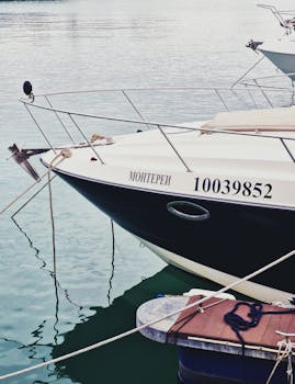 Close-up of a sleek yacht named Monterei docked at a calm marina, showcasing nautical details.