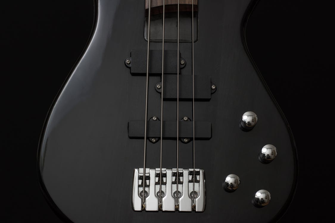 Free Black 4 Stringed Guitar Stock Photo