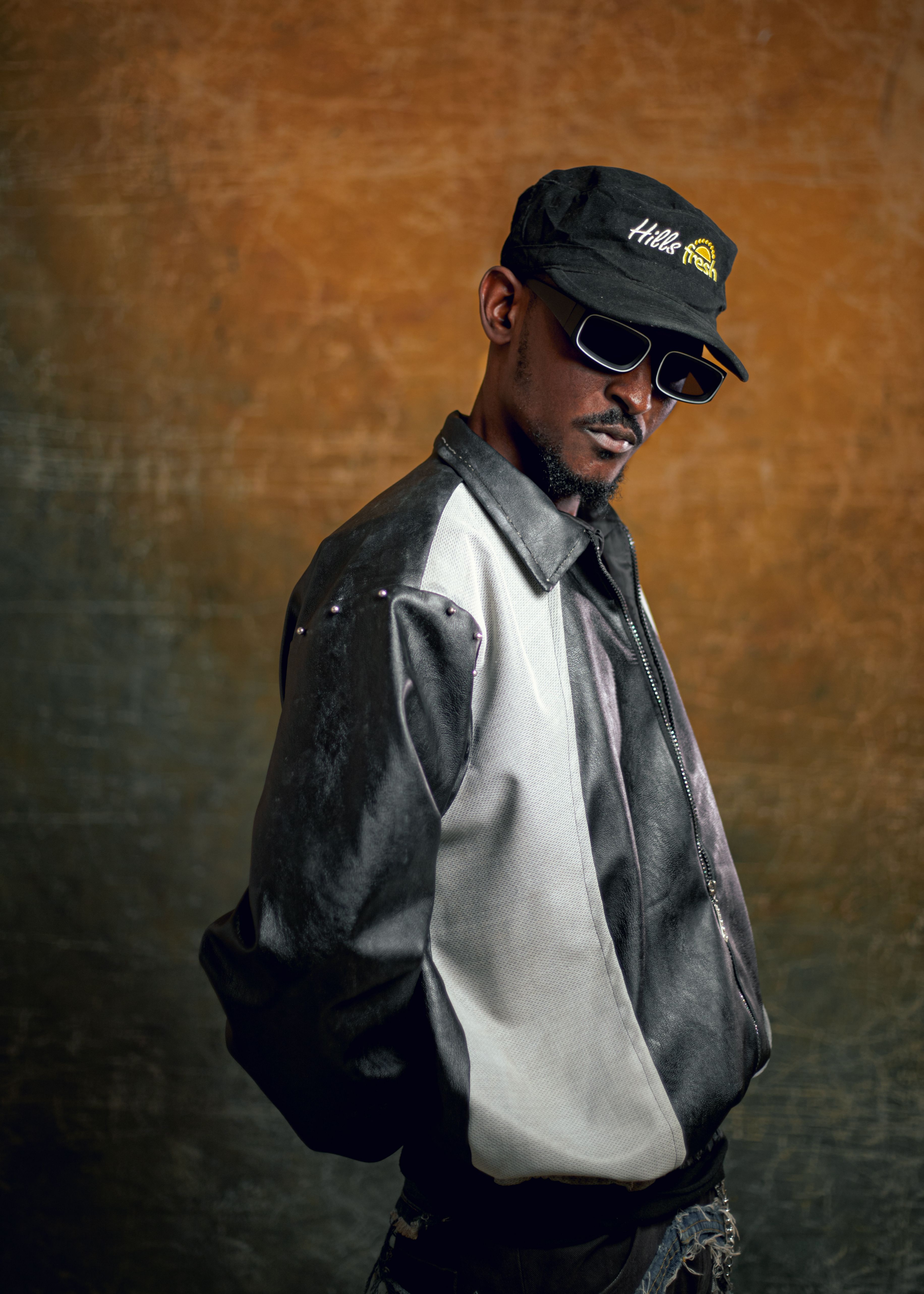 Portrait of a stylish man wearing sunglasses and a cap with attitude.
