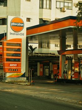 A view of an IndianOil gas station with pumps and signage in a city environment. — photo by Jibin Yesudasan