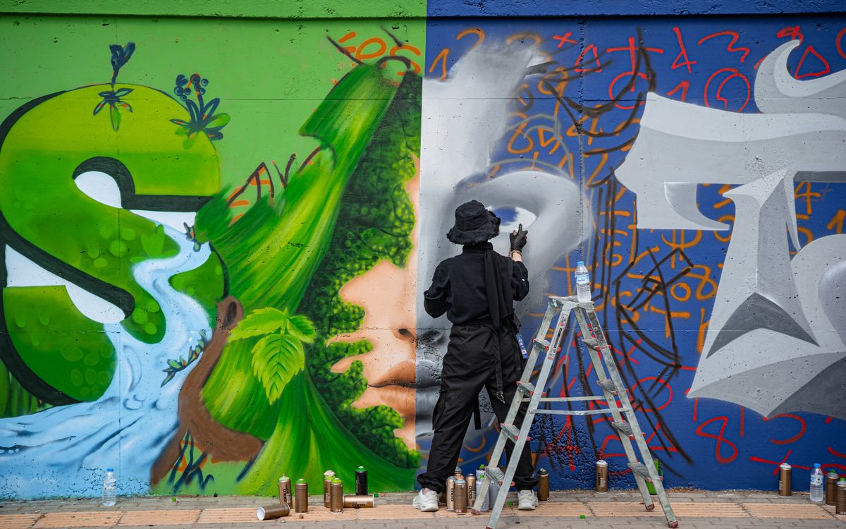 Artist Creating Vibrant Wall Mural Graffiti · Free Stock Photo