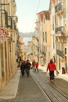 Explore Lisbon's vibrant street life with this scenic view of a historical neighborhood.