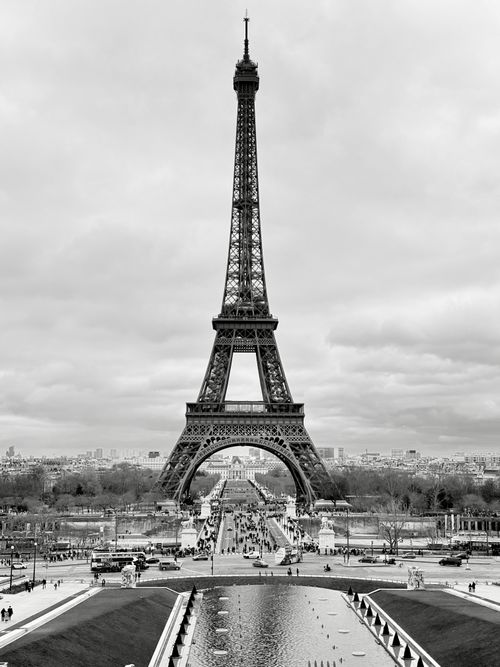 Free Iconic Eiffel Tower, Paris captured in black and white against a cloudy sky. Stock Photo