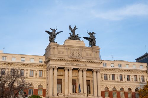 Free Front view of Spain’s Ministry of Agriculture with angel statues atop in Madrid. Stock Photo