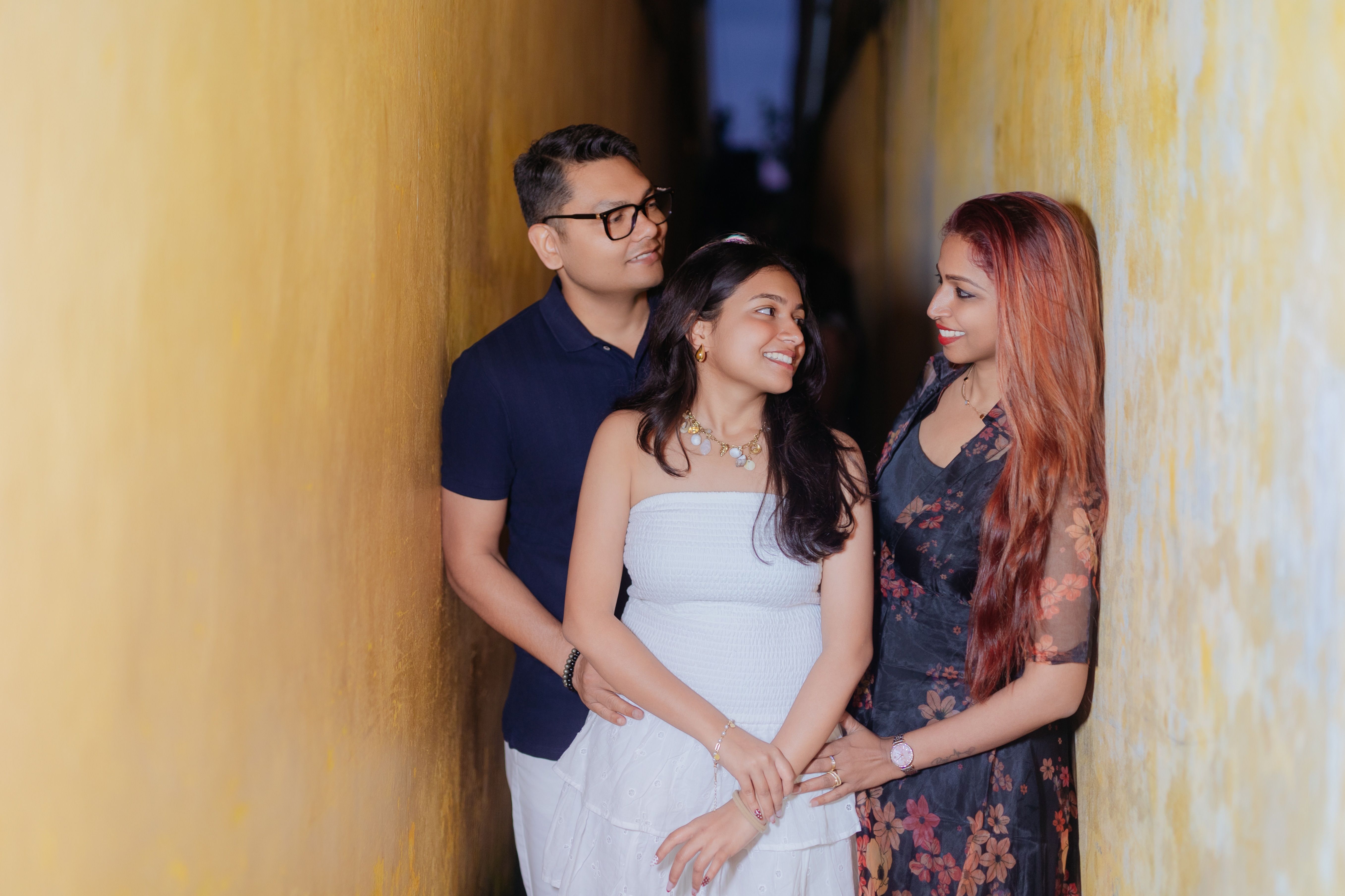 A joyful family stands together in a narrow, vibrant alleyway, bonding and smiling.